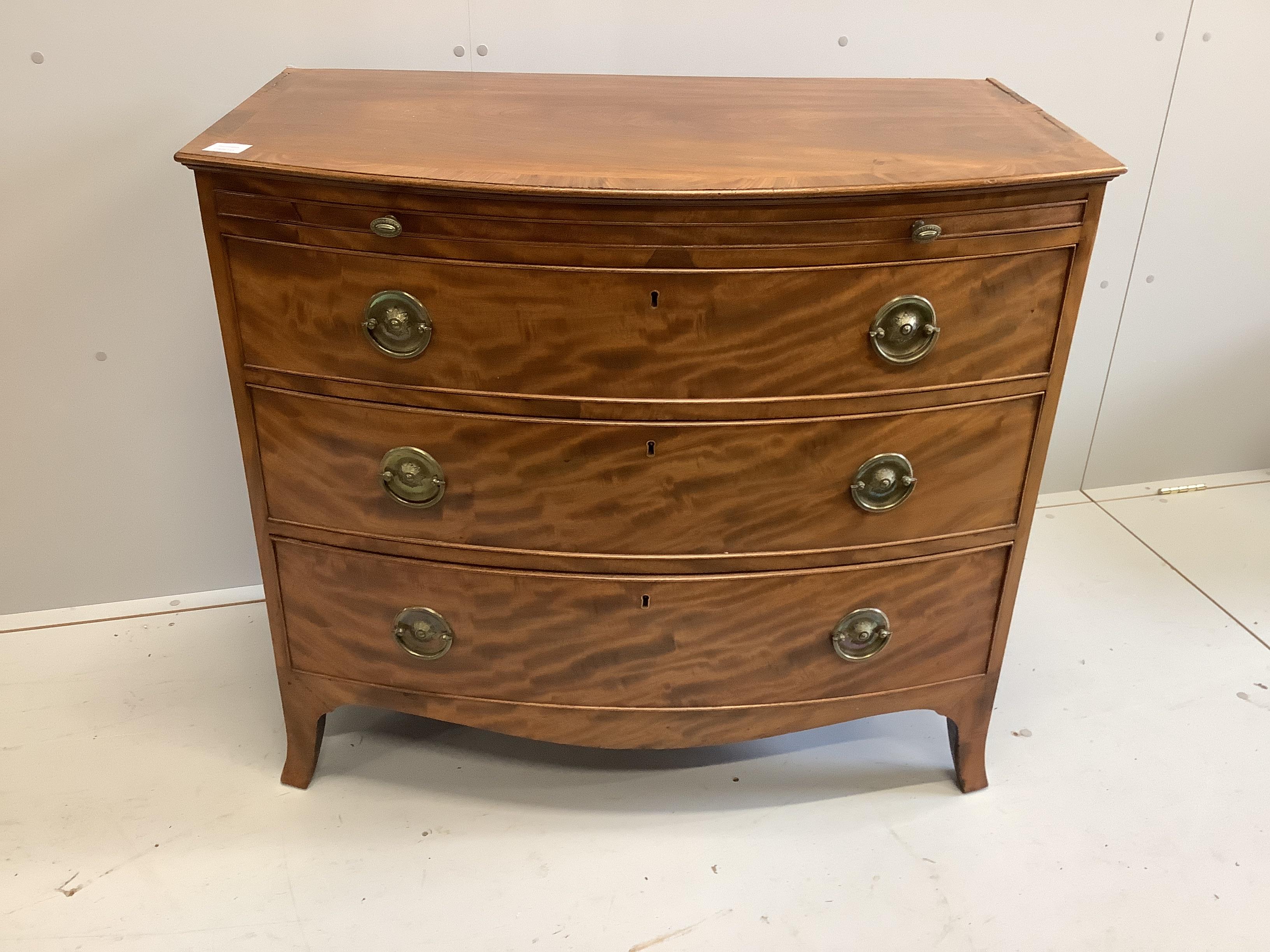 A Regency mahogany bow front chest of three drawers, fitted slide, width 98cm, depth 59cm, height 87cm